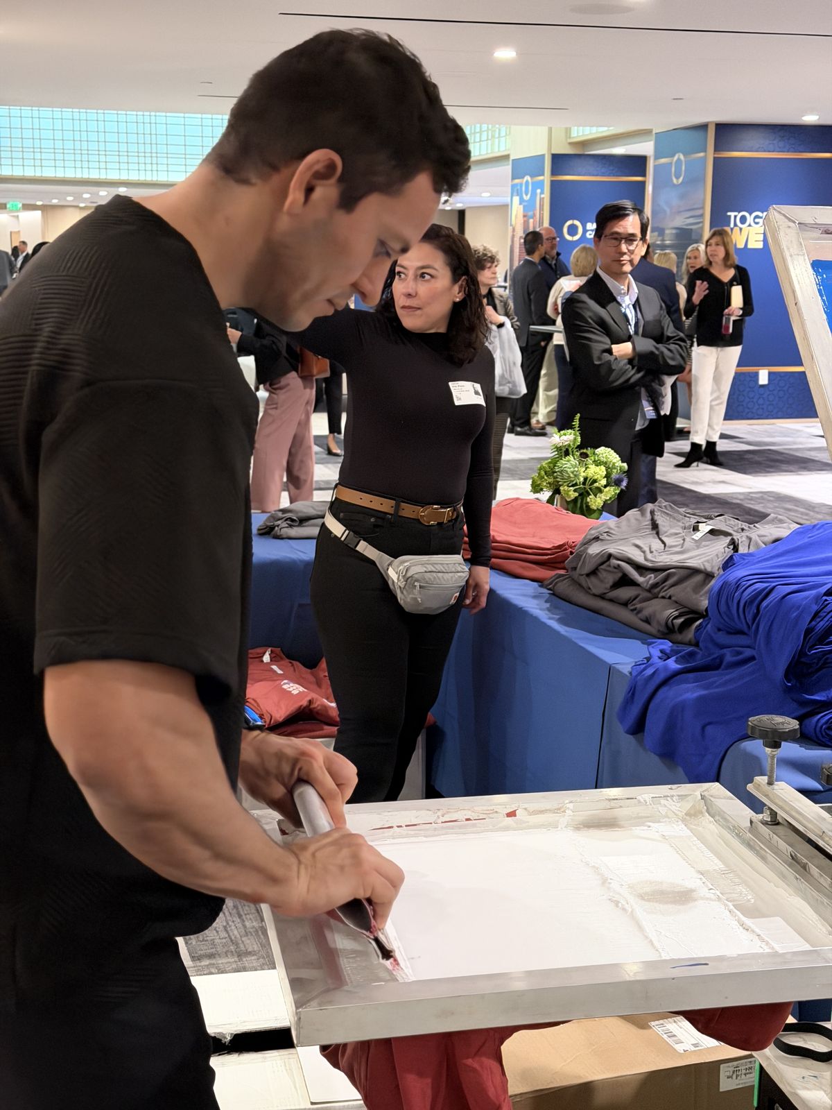 Merch Troop live printing — fresh prints off the platen